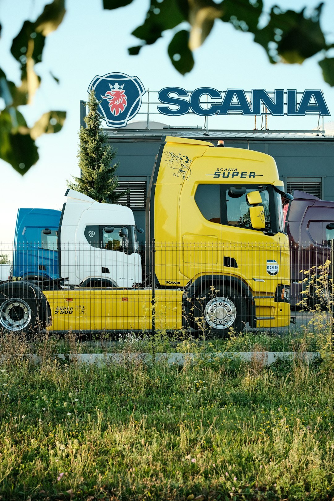 Trucks parked in front of Scania warehouse at daytime